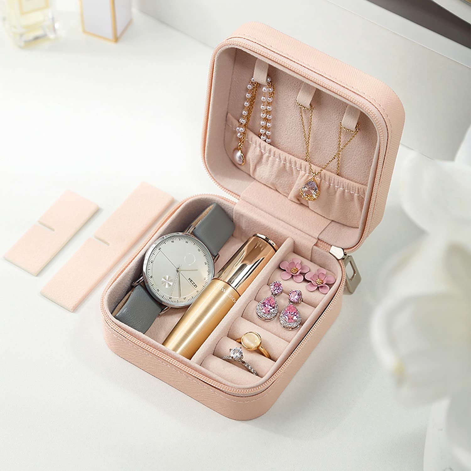 Minimalist jewellery organizer with soft faux leather exterior in sea green and blush pink.