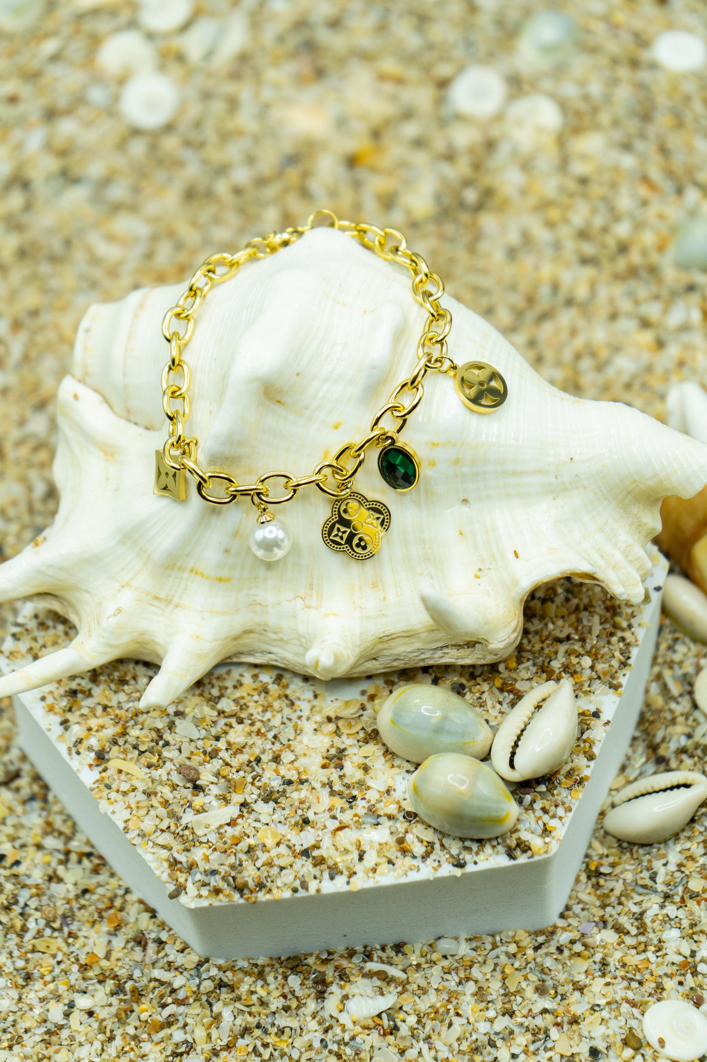 Elegant charm bracelet with yellow gold plating and anti-tarnish finish.