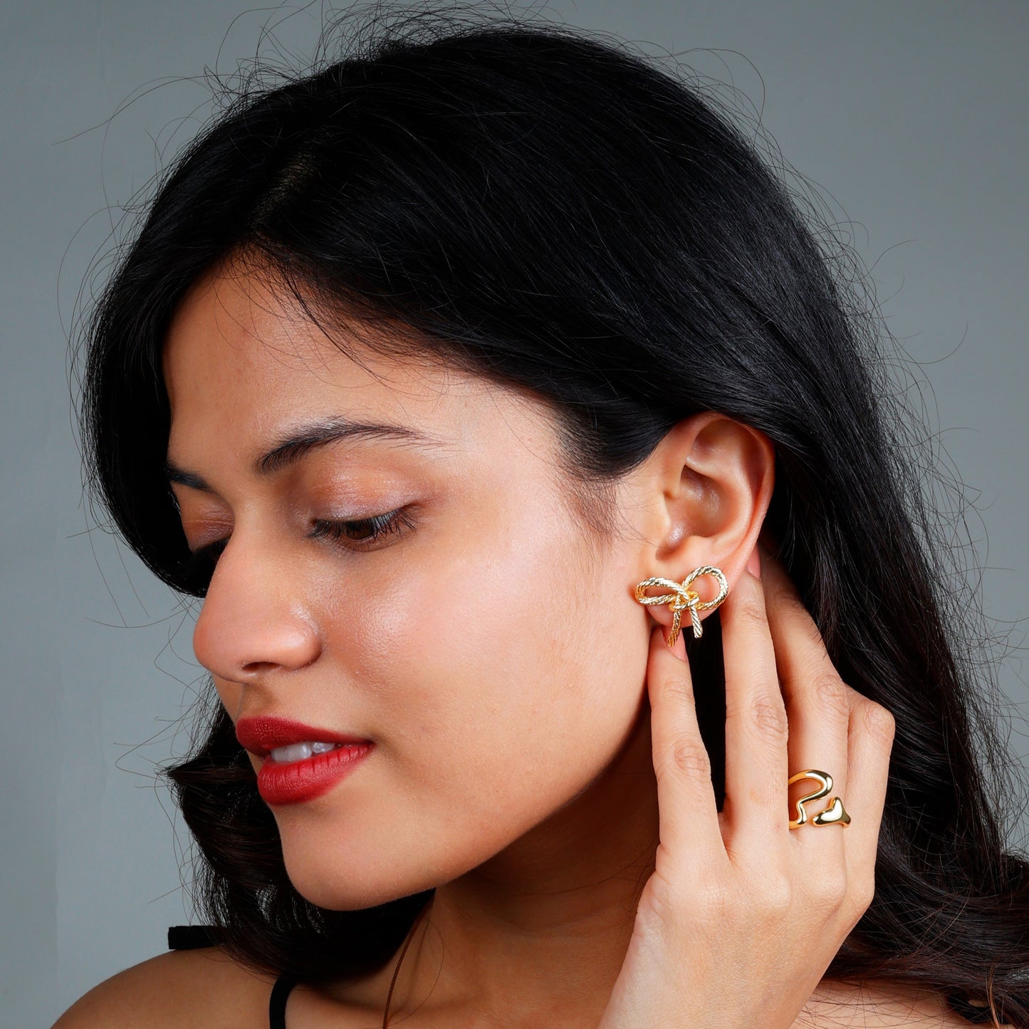 Chic bow earrings with yellow gold plating, anti-tarnish finish, and hypoallergenic design.