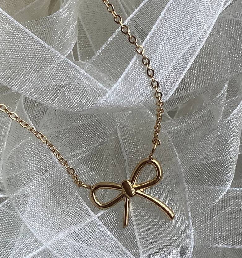 Peppy Pink gold necklace with ribbon-style charm