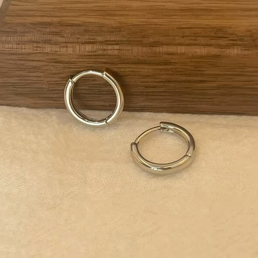 Chunky silver hoop earrings with high-shine finish
