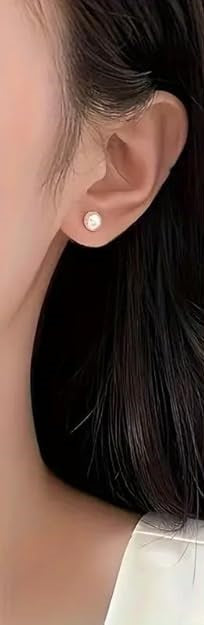 Delicate pearl stud earrings featuring minimalist design and classic charm.