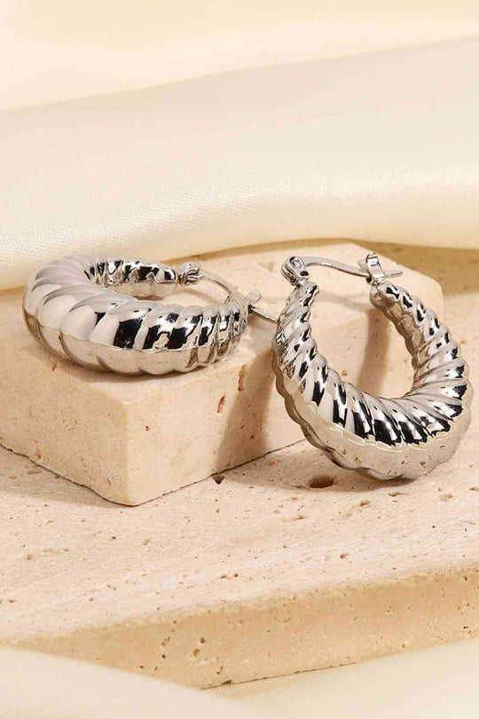 Textured twist hoop earrings in silver and gold finish