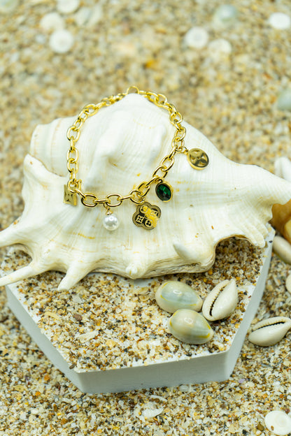Elegant charm bracelet with yellow gold plating and anti-tarnish finish.