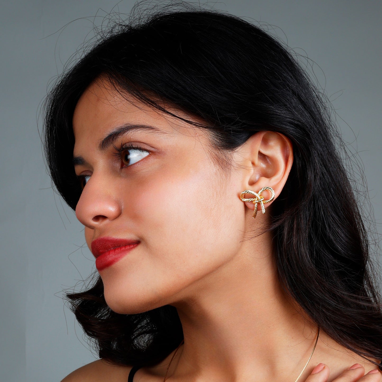 Chic bow earrings with yellow gold plating, anti-tarnish finish, and hypoallergenic design.