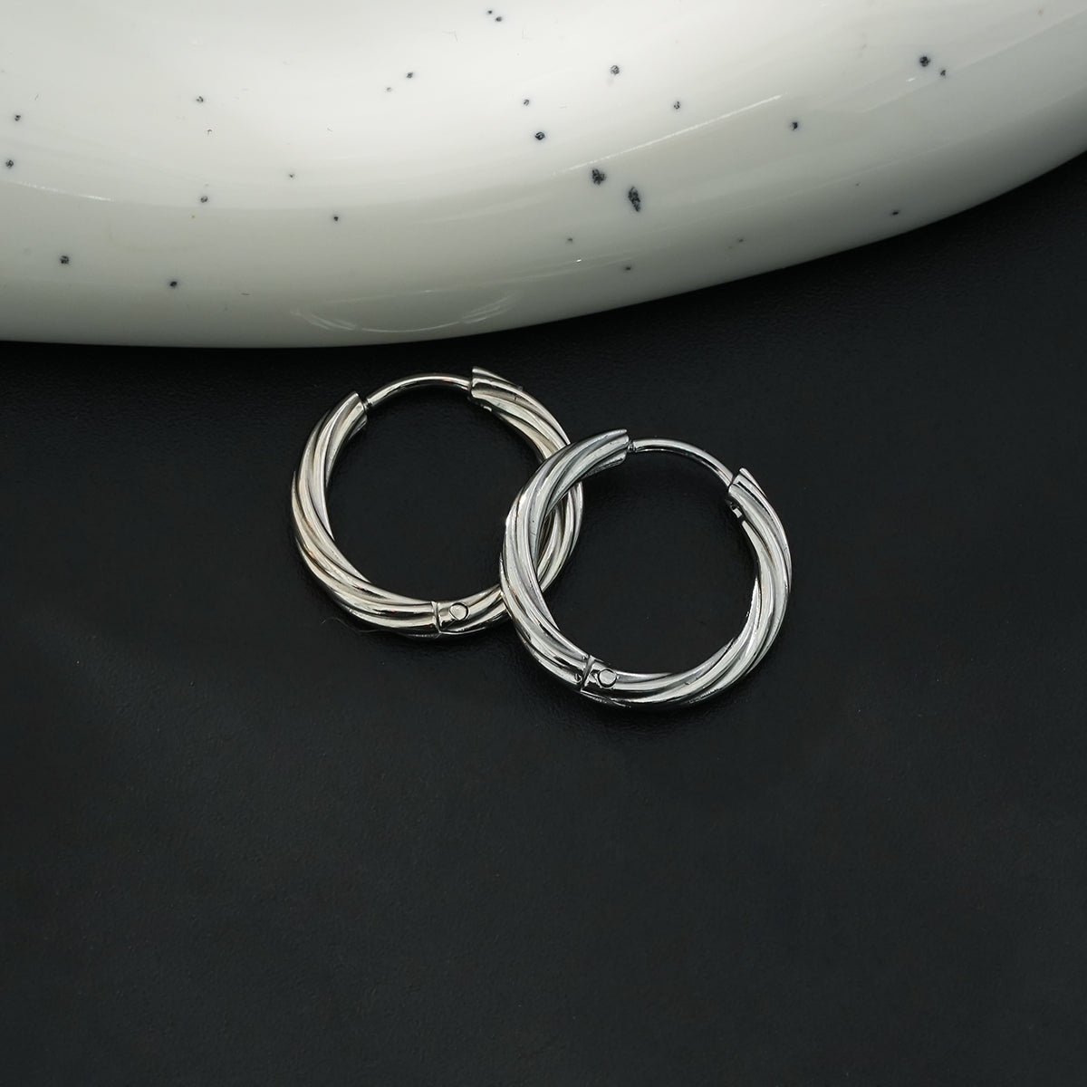 Silver statement hoop earrings with a symbolic touch