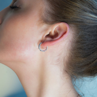 Elegant Infinity Hoops in Silver finish, Rhodium Plated for shine and durability.